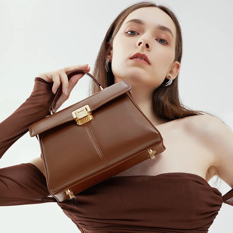 Genuine leather women's shoulder bag with clasp closure showing interior hidden compartment
