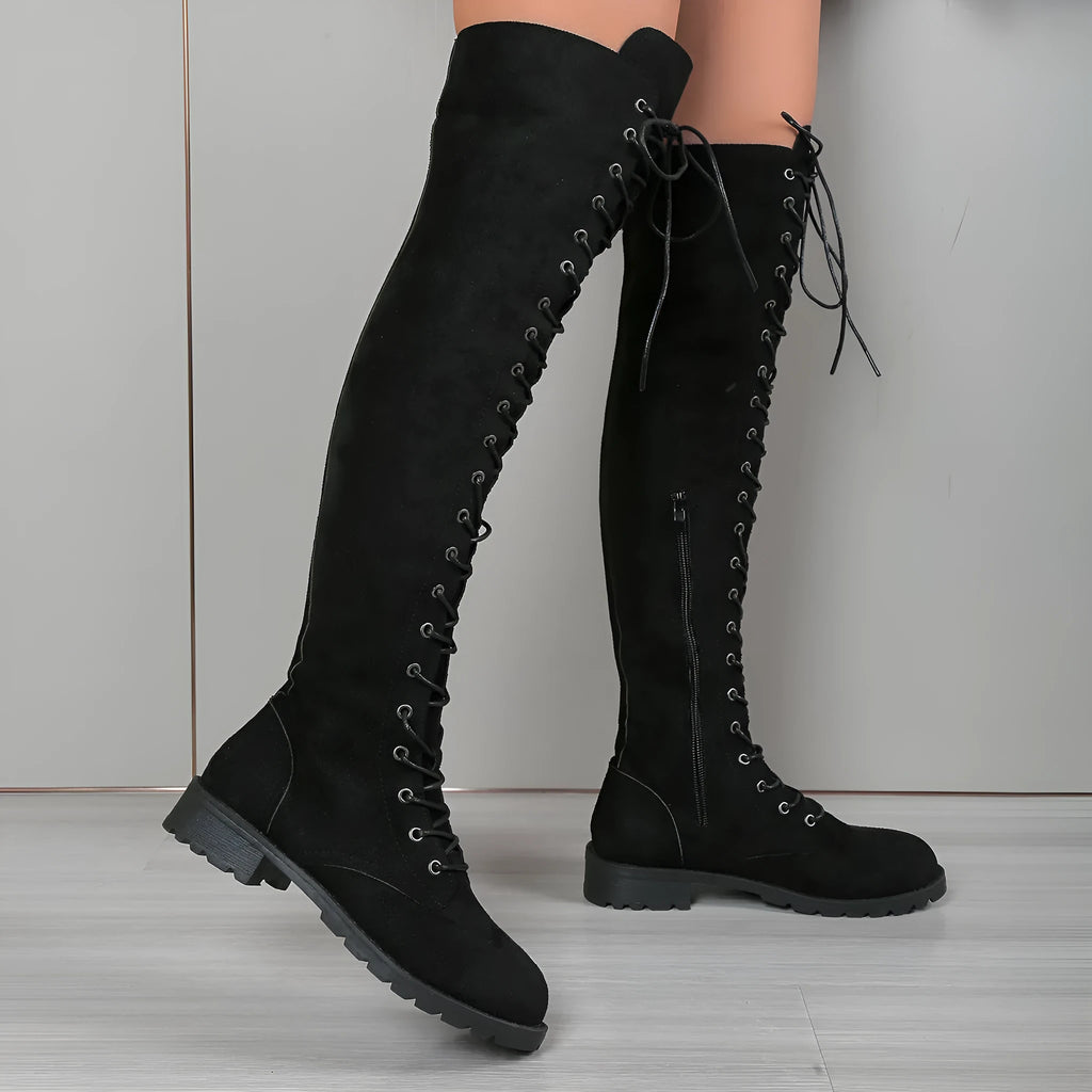 Black lace-up over-the-knee boots with a round toe, flat rubber sole, and stitching detail on the artificial PU upper.