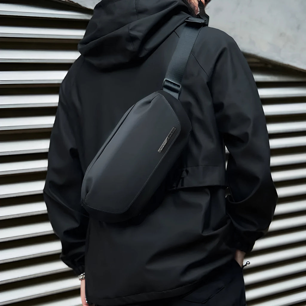 Black men's messenger bag made from Oxford cloth with cross-body strap and street trend design