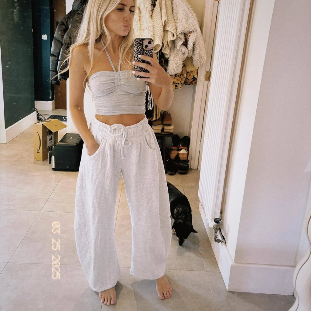 Loose cropped sweatpants with drawstring waist in apricot colour showing side pockets and street fashion styling