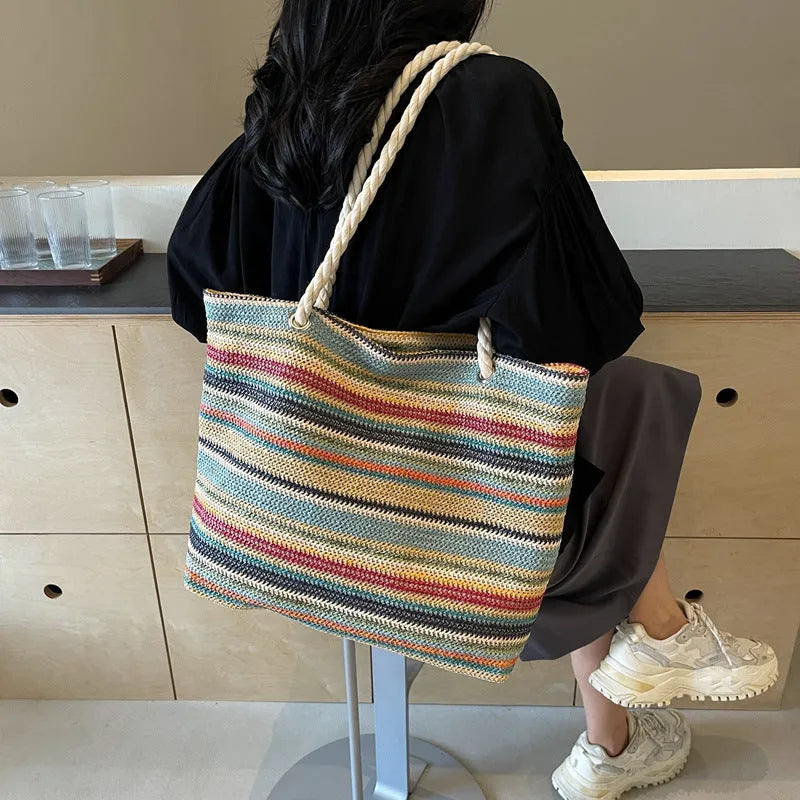 Blue woven nylon shoulder bag with large capacity and straw-style texture showing single-shoulder strap and polyester lining.