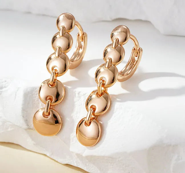 A pair of gold-coloured retro long round circle earrings with a woven texture, made from copper.
