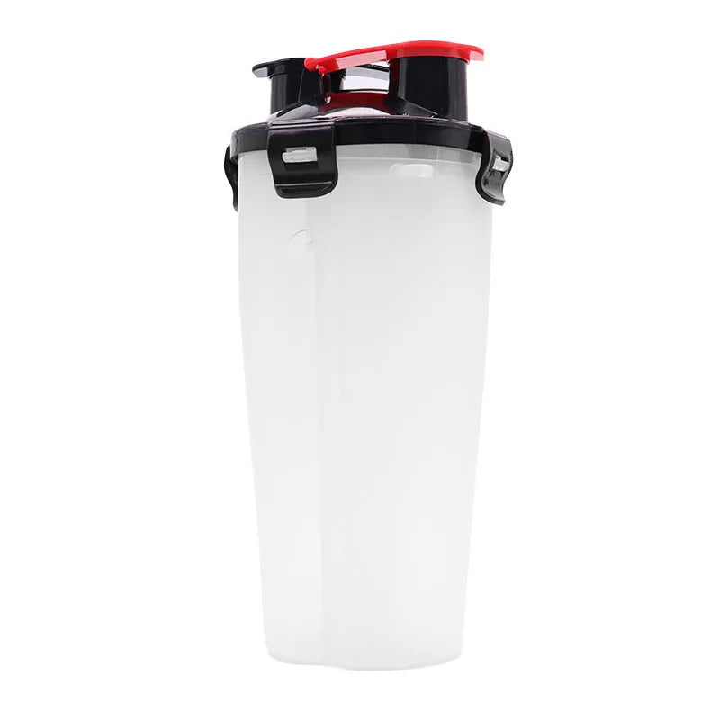 White portable pet water and food cup with bowl attachment on grass.