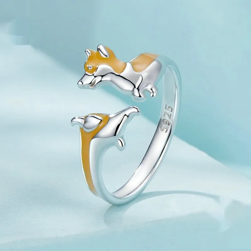 Silver corgi pet ring on a finger, showing cartoon animal design and adjustable band.