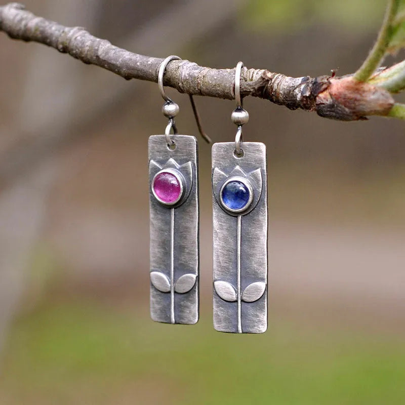 Geometric antique finish red sapphire earrings with elliptical elements and electroplated metal construction