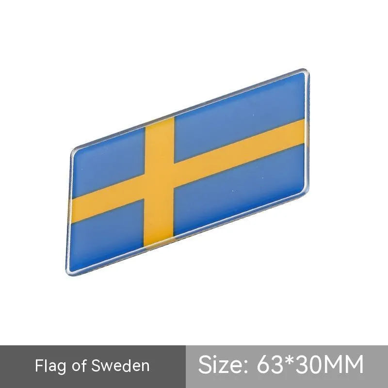 Aluminium national flag car sticker in a parallelogram shape measuring 6.3 by 3 centimetres.