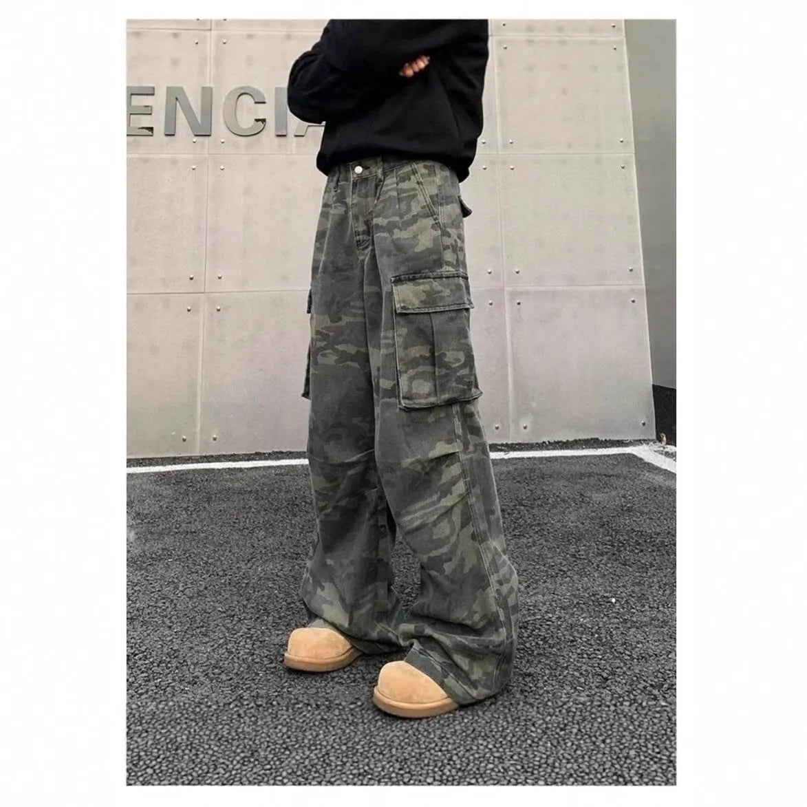 Washed camouflage cargo trousers with multiple pockets on a mid-waist fit.