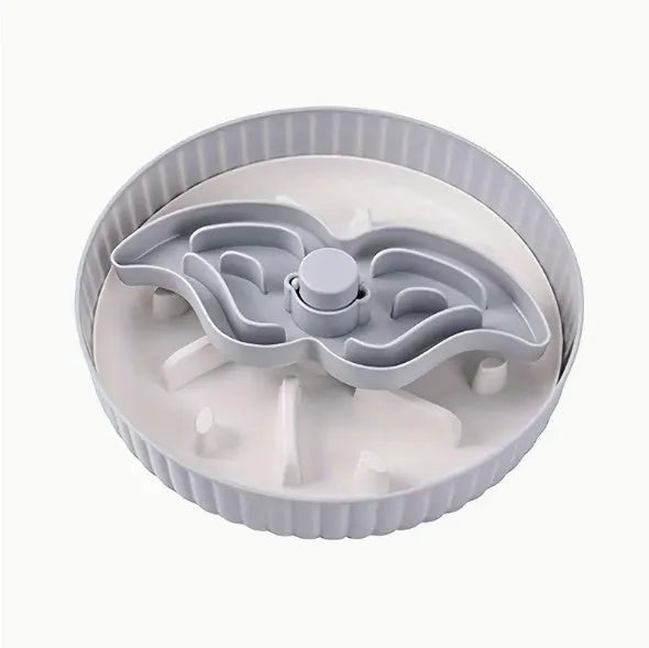 Plastic pet bowl with a central silicone slow feeder mat in a windmill pattern, shown in blue.