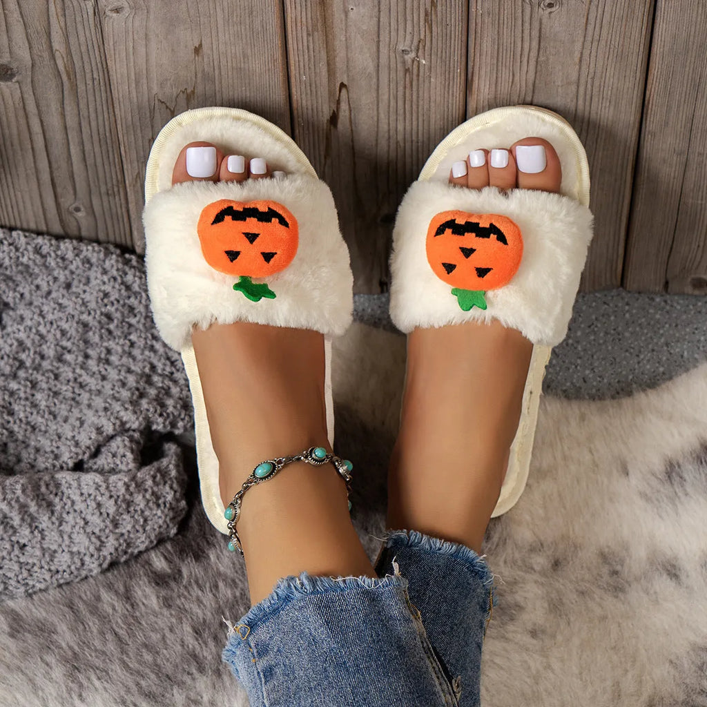 Halloween cartoon pumpkin design open-toe plush slippers on a white or yellow synthetic fur upper with PVC sole.