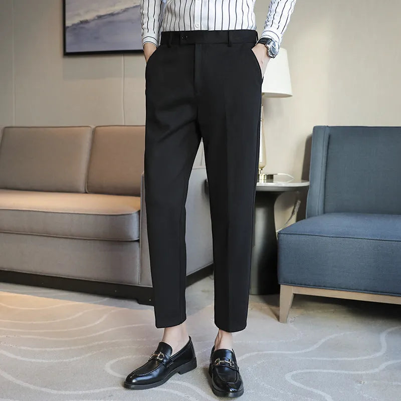 Brown straight leg corduroy trousers for men laid flat, showing slim fit and elastic waistband detail.