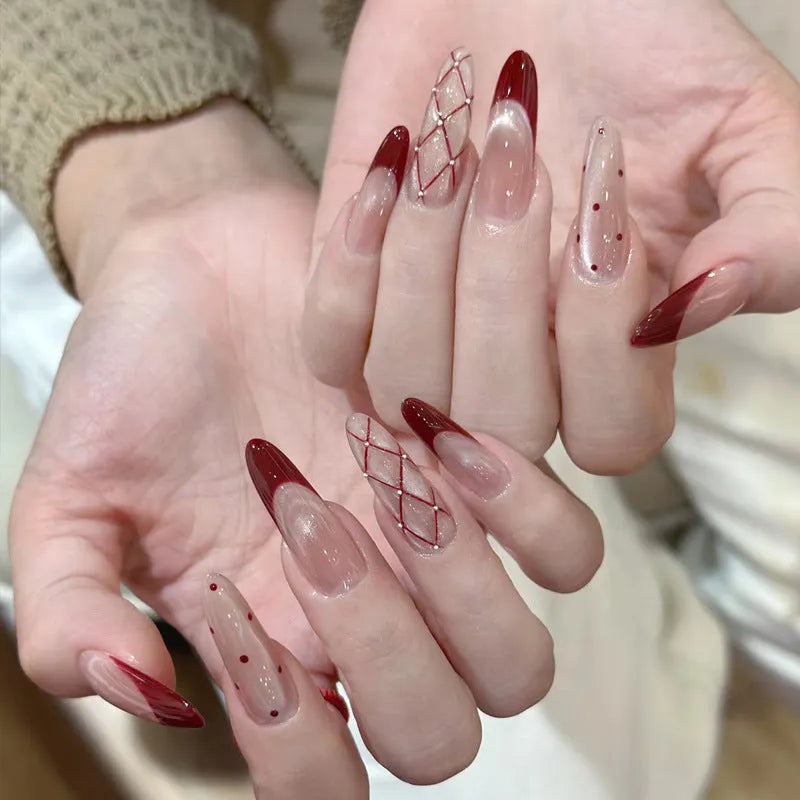 Pack of false nails with assorted nail art designs and adhesive tabs for temporary wear.