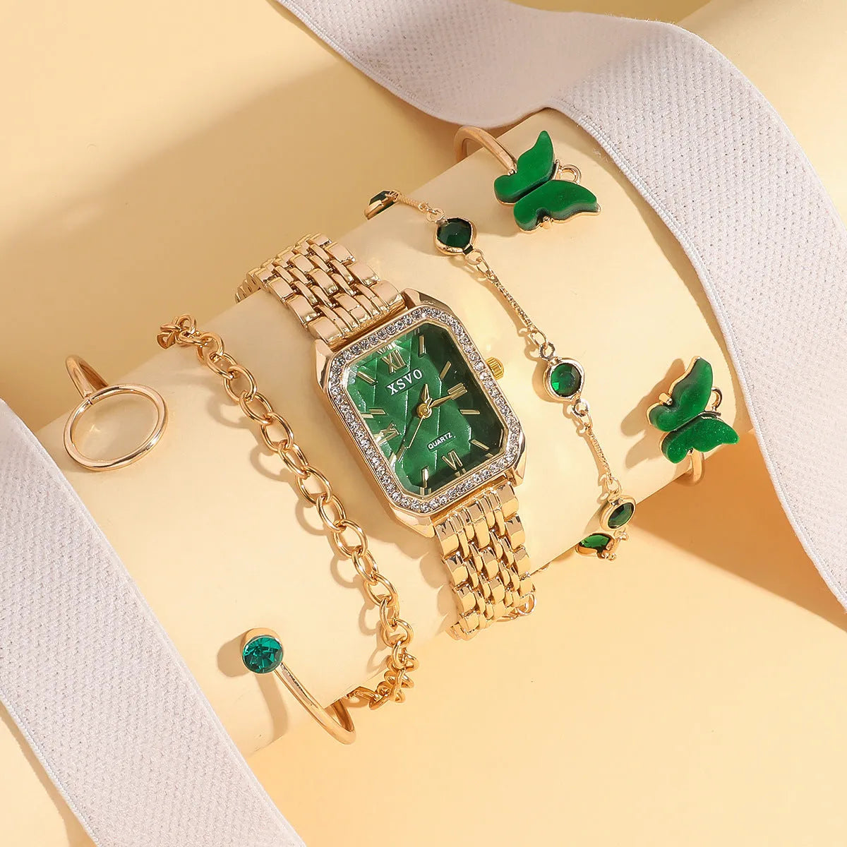 Gold green square women's watch with four matching butterfly bracelets on white background