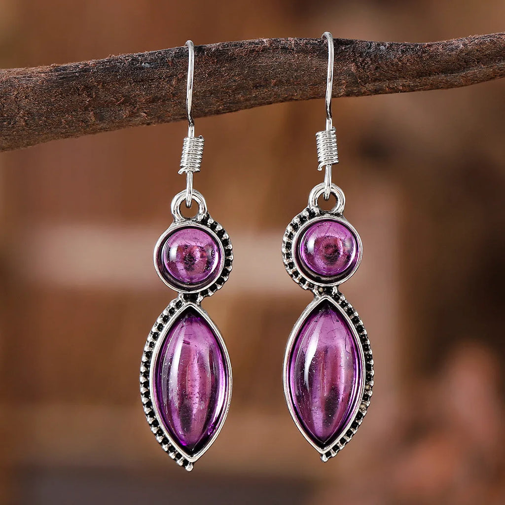 Pair of vintage geometric pendant earrings in black and purple zinc alloy with round retro design
