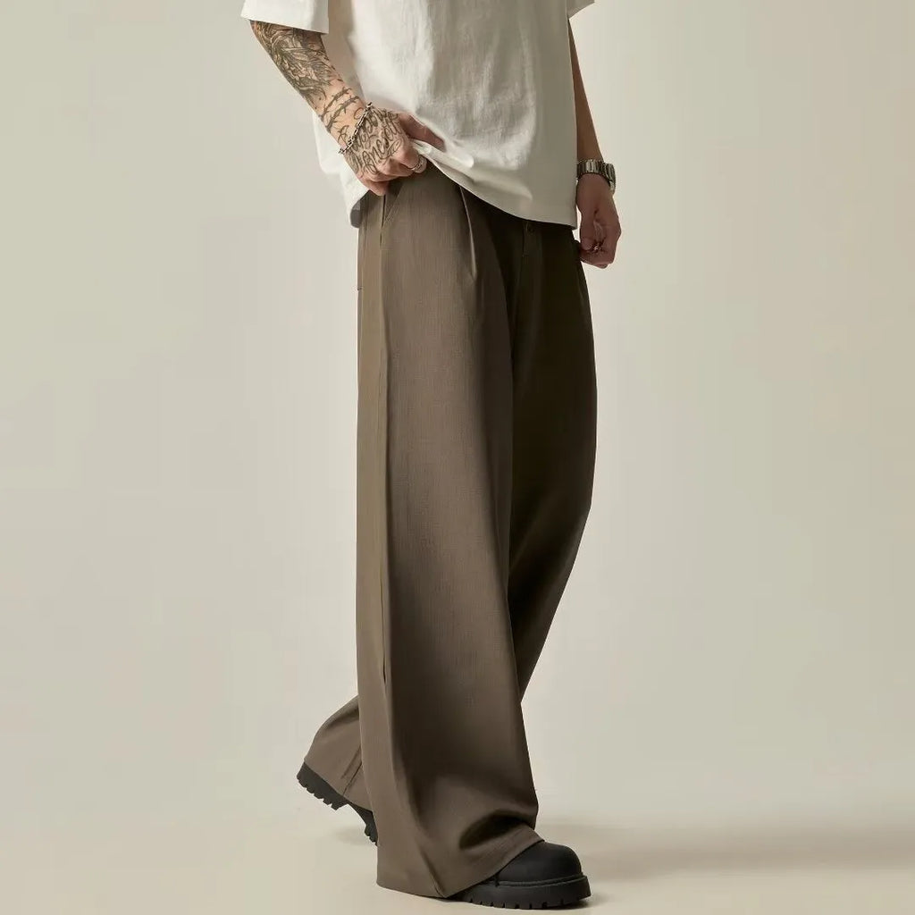 Men's black vertical tube wide-leg trousers showing cotton blend fabric texture and straight-leg silhouette