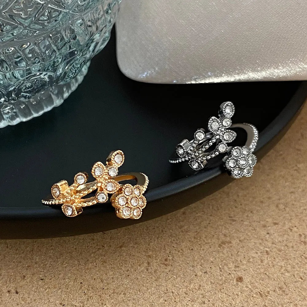 Women's copper open ring with white and gold flower leaf design and diamond style finish