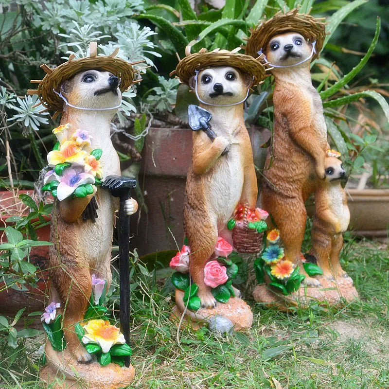Three straw hat mongoose resin ornaments: mother and son, with rake, and with shovel figurines.