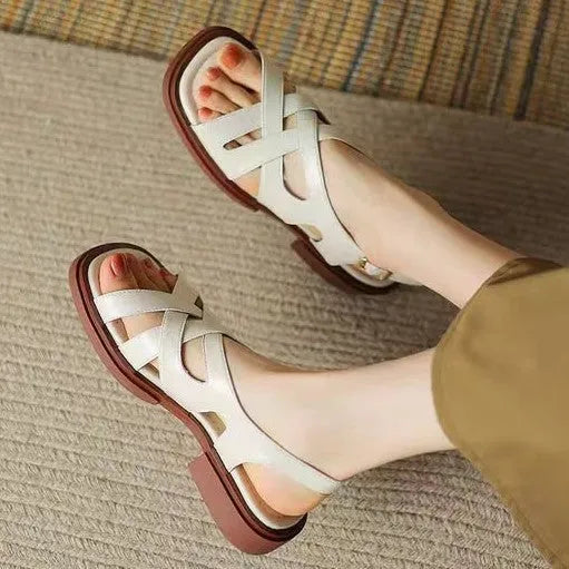 Women's patent leather low heel square toe beach sandals in black colour with cross strap design