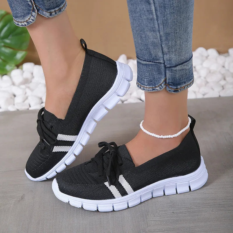 Women's lace-up mesh trainers with flat rubber sole, round toe and shallow mouth, shown in grey, black, orange and brown