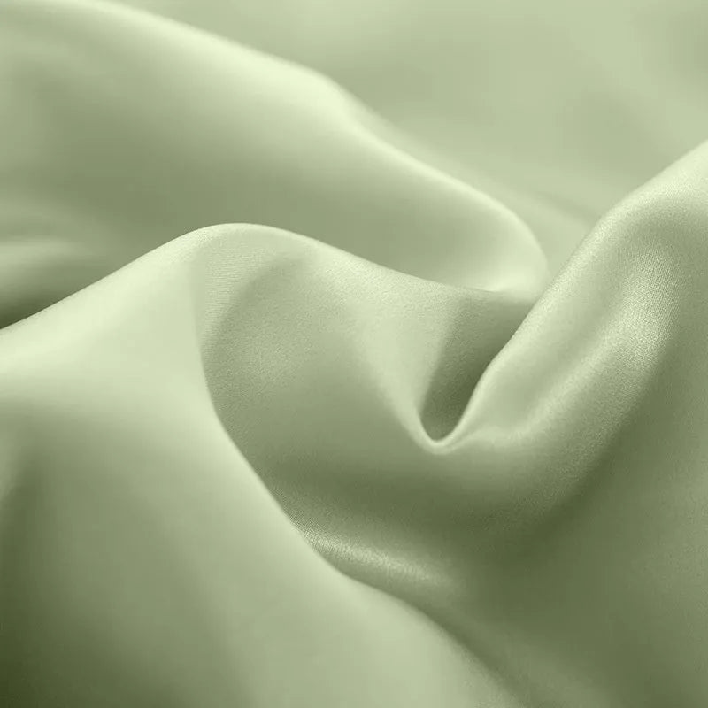 Double-sided silk duvet cover showing reversible solid colours in lotus pink and pea green options