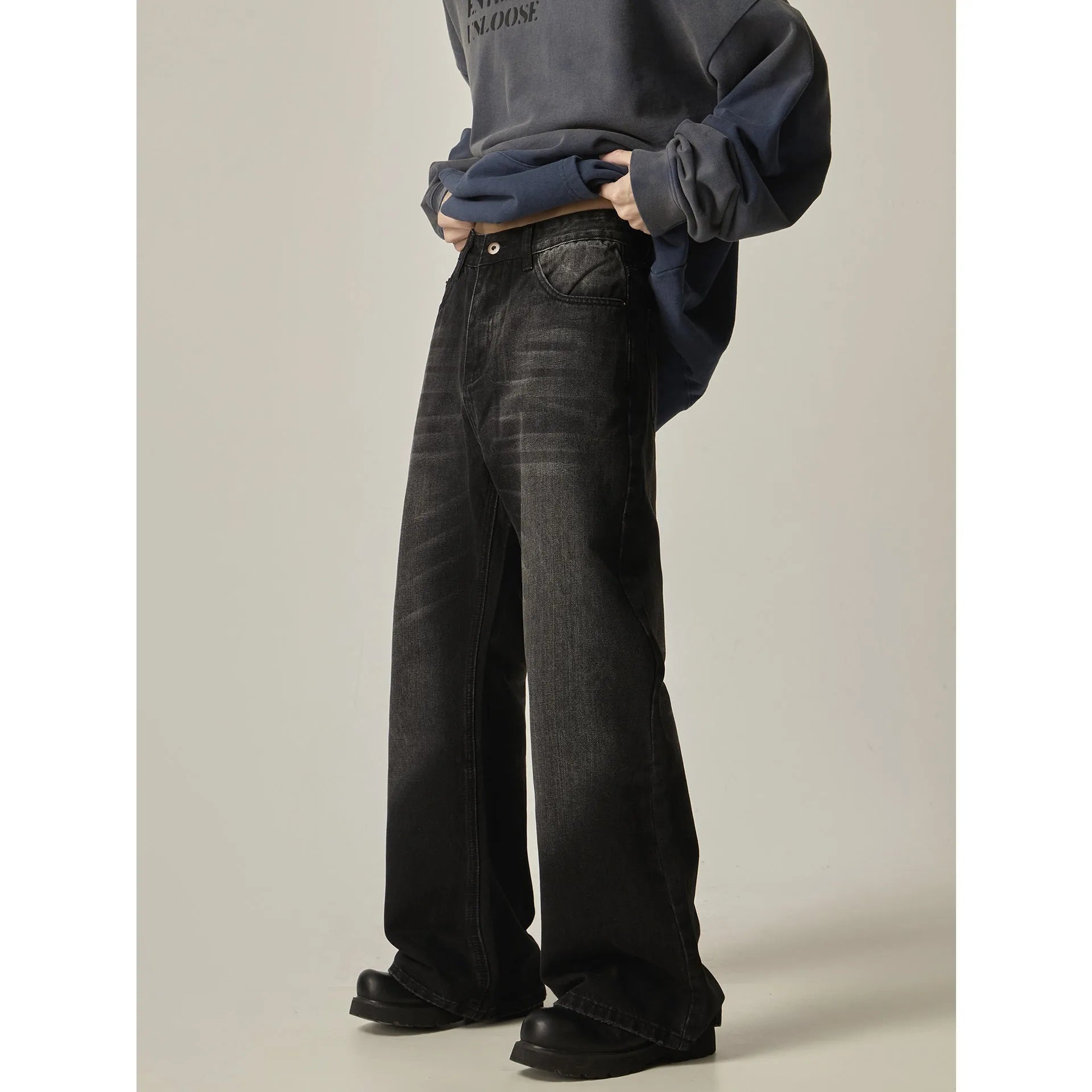 Black loose straight jeans with retro styling and zipper fly on mannequin