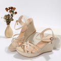 Women's black wedge sandals with fish mouth toe open design and fabric upper.