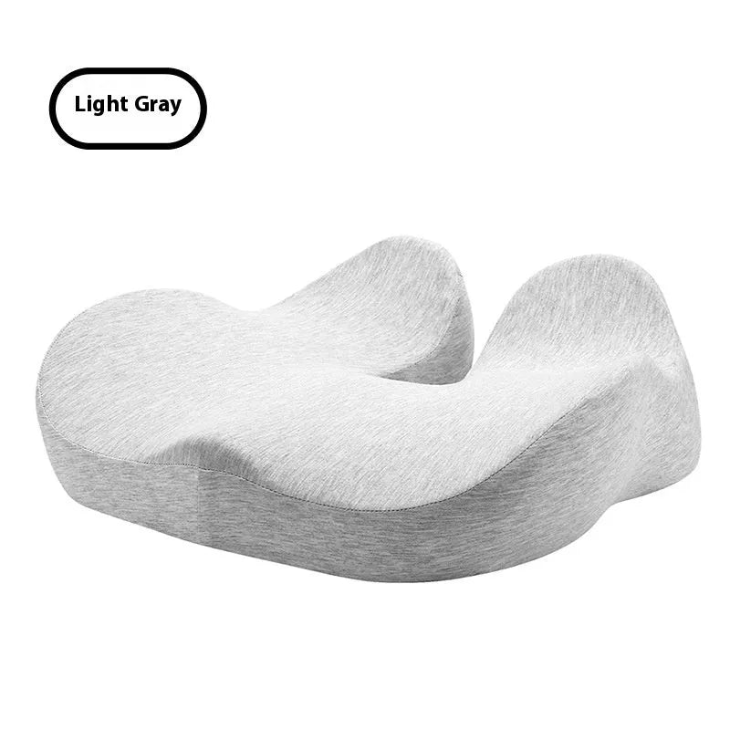 Light grey memory foam office chair cushion on a wooden chair seat.