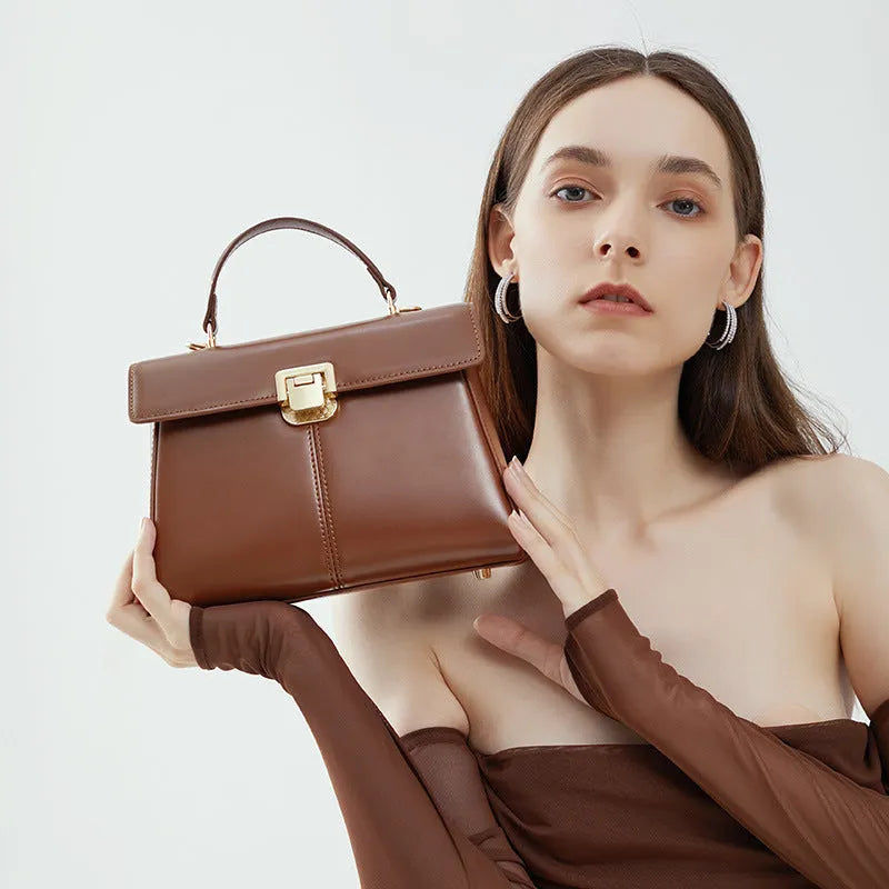 Genuine leather women's shoulder bag with clasp closure showing interior hidden compartment