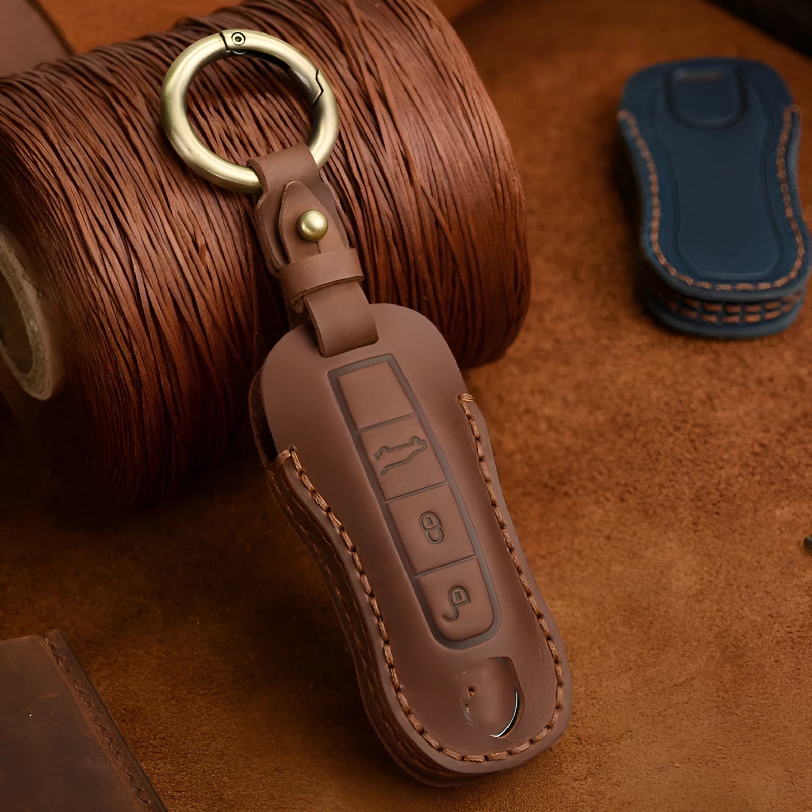 Genuine cowhide leather Porsche key cover in retro bag buckle style, blue and brown colour options.