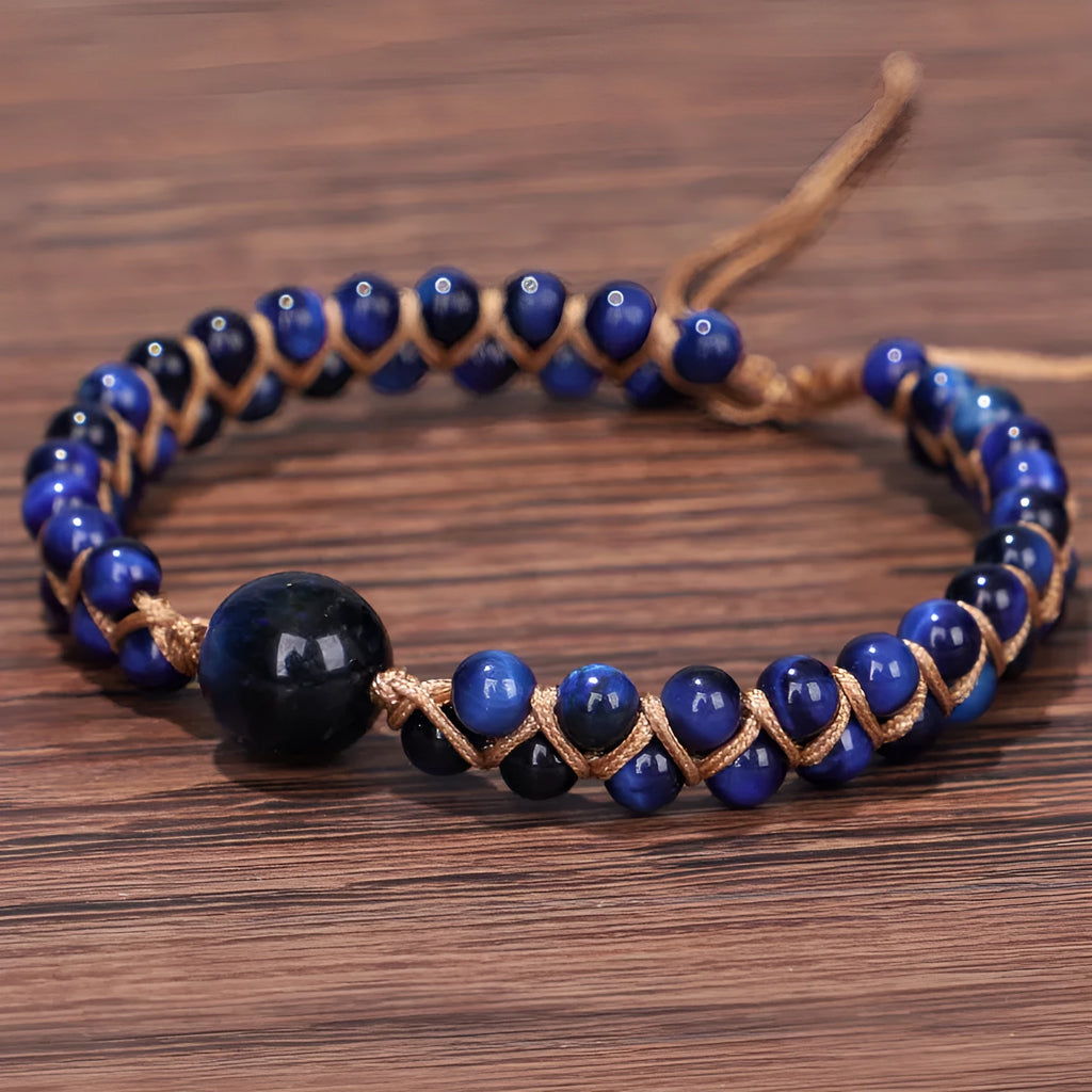 Close-up of a handmade woven pull bracelet with geometric pattern in blue Tigereye stone beads.