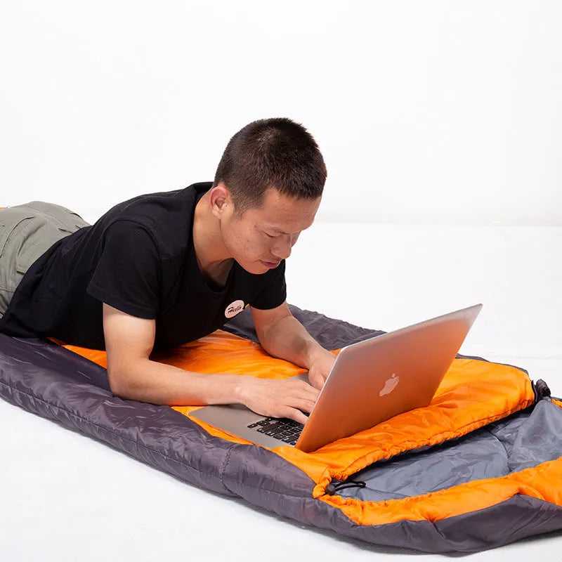 Envelope sleeping bag in orange and gray colour for camping and outdoor travel