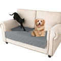 Double-sided waterproof dog sofa cushion showing dark grey and light grey reversible sides on a sofa.