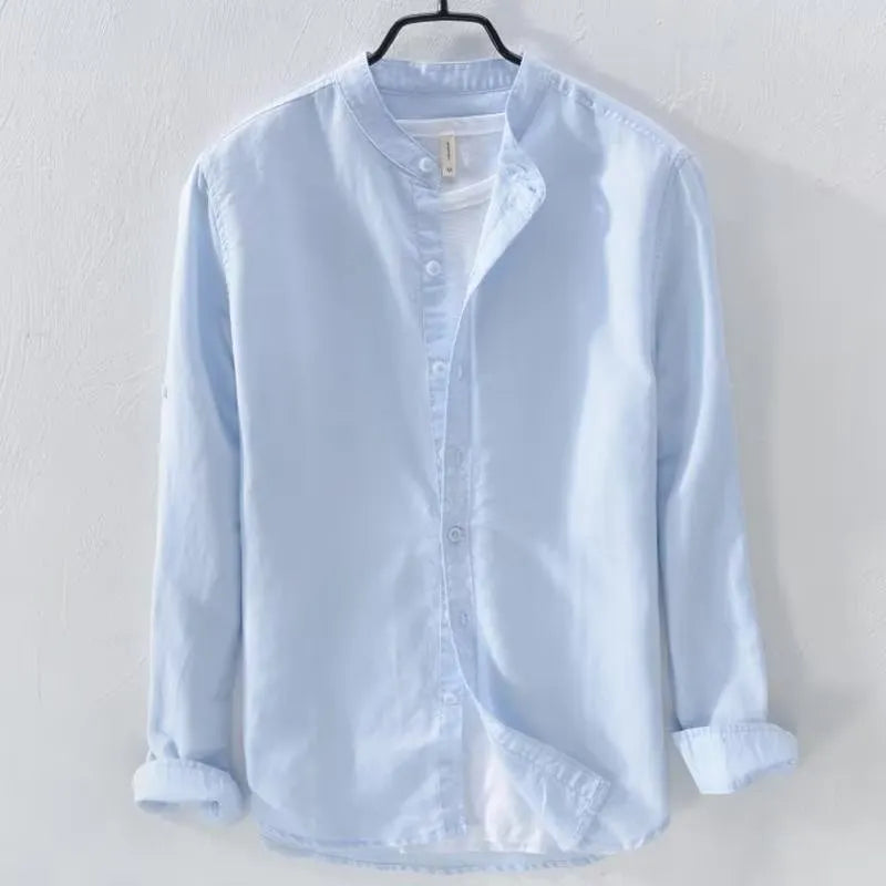 A man's loose fit long sleeve casual shirt in a cotton linen blend, shown in a solid colour.