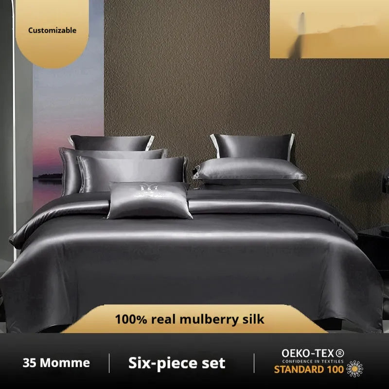 Silk four-piece quilt cover set in solid colour displayed on bed with pillowcases