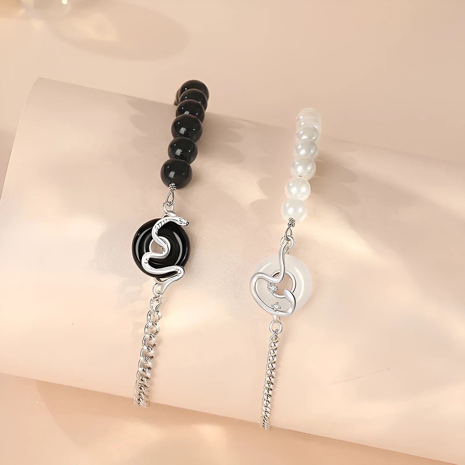 925 sterling silver couple bracelet with snake design and safety buckle on a wrist.