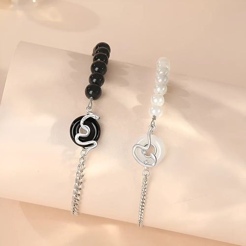 925 sterling silver couple bracelet with snake design and safety buckle on a wrist.