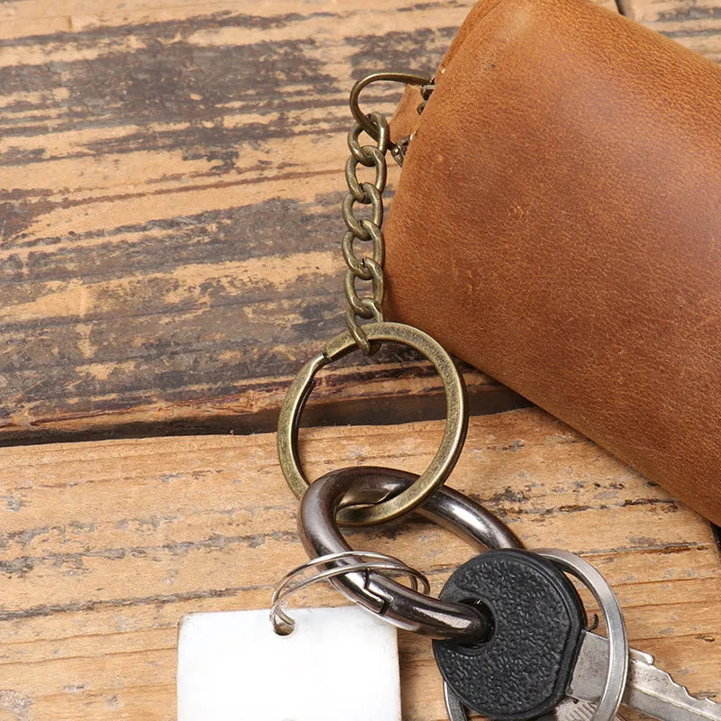 Men's leather clutch coin purse in first layer cowhide with chain, shown in brown yellow, dark brown or black