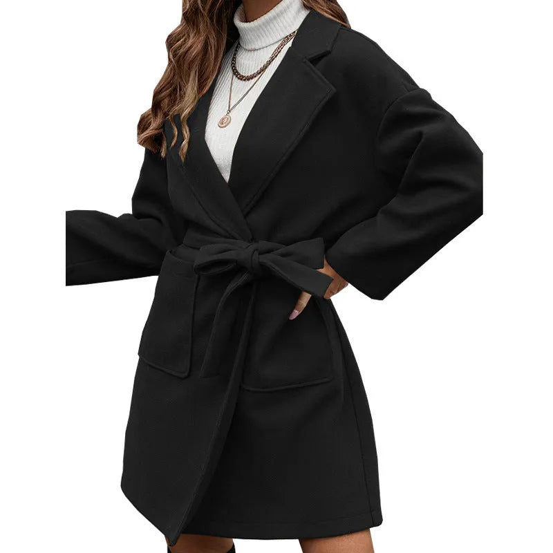 Brown minimalist long sleeve casual coat with lapel, buttons, and a split waist belt on a hanger.