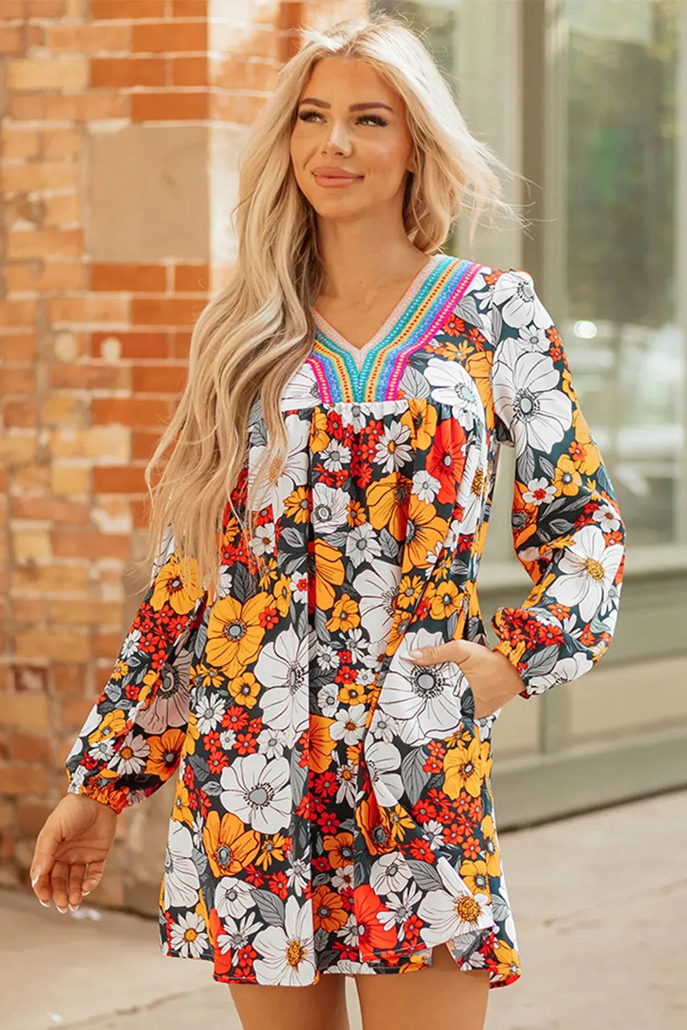Orange floral print women's mini dress with V-neck, long sleeves, and lace trim