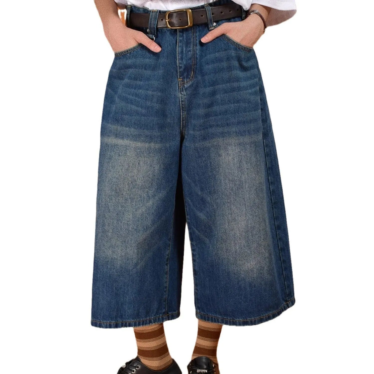 Man wearing light blue straight leg loose fit denim shorts on a summer day.