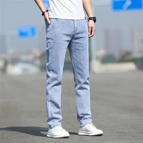 Man wearing smoky gray low-waist straight-leg jeans made from high-elasticity rabbit fur fabric.