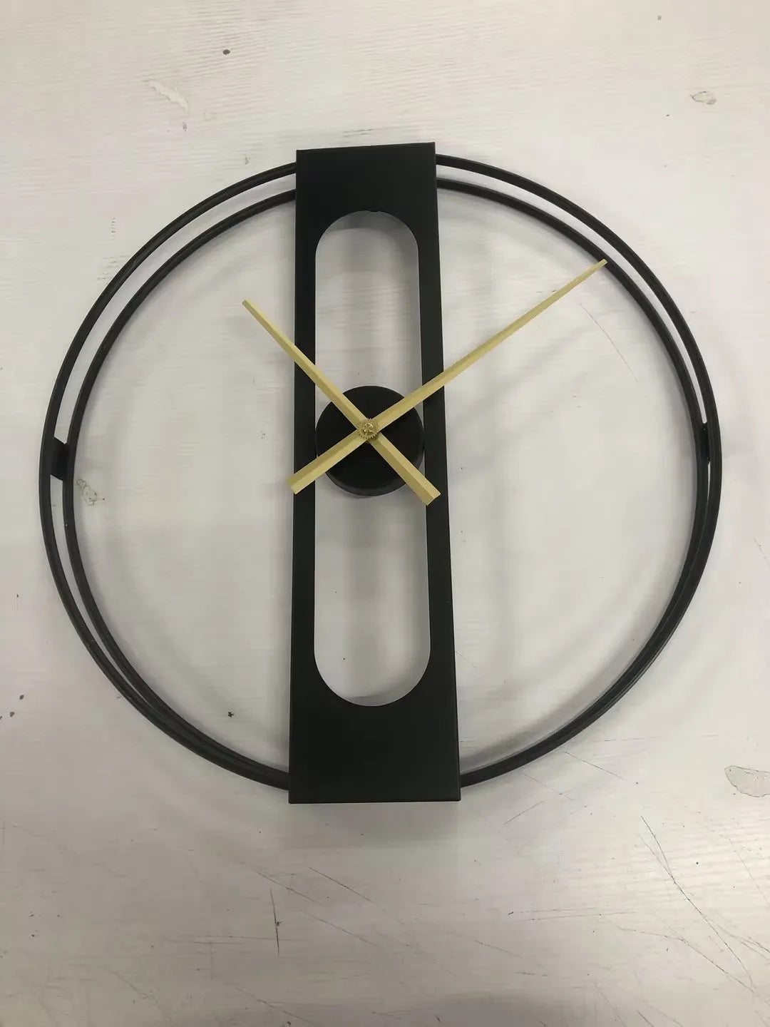 Round metal wall clock showing black and gold colour options, 50cm in diameter.