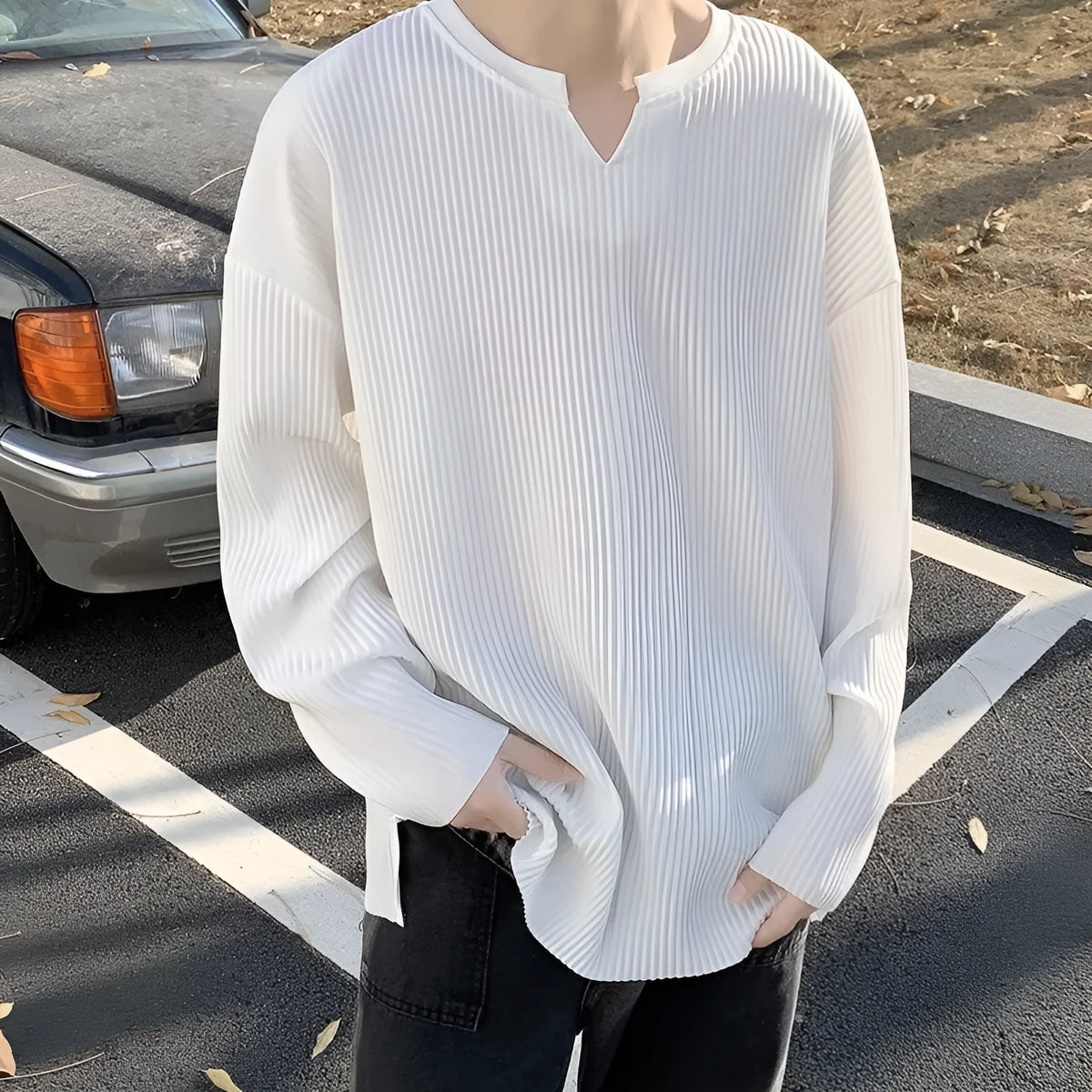 Plus size women's loose grey striped texture long sleeve pullover top on a hanger.