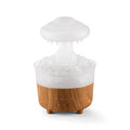 Rain cloud shaped humidifier with wood grain finish emitting mist and glowing with 7-color LED light