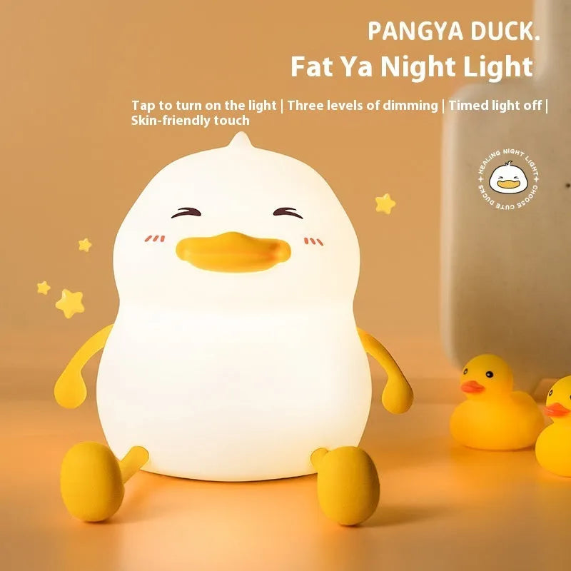 Chubby silicone night light with LED glow functioning as a desktop phone holder