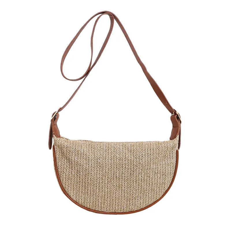 Women's woven straw crossbody bag with a single strap and internal organisation pockets.