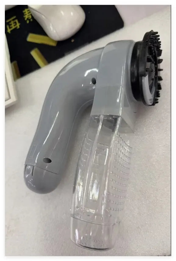 Grey handheld pet grooming vacuum cleaner with soft rubber head for dogs and cats