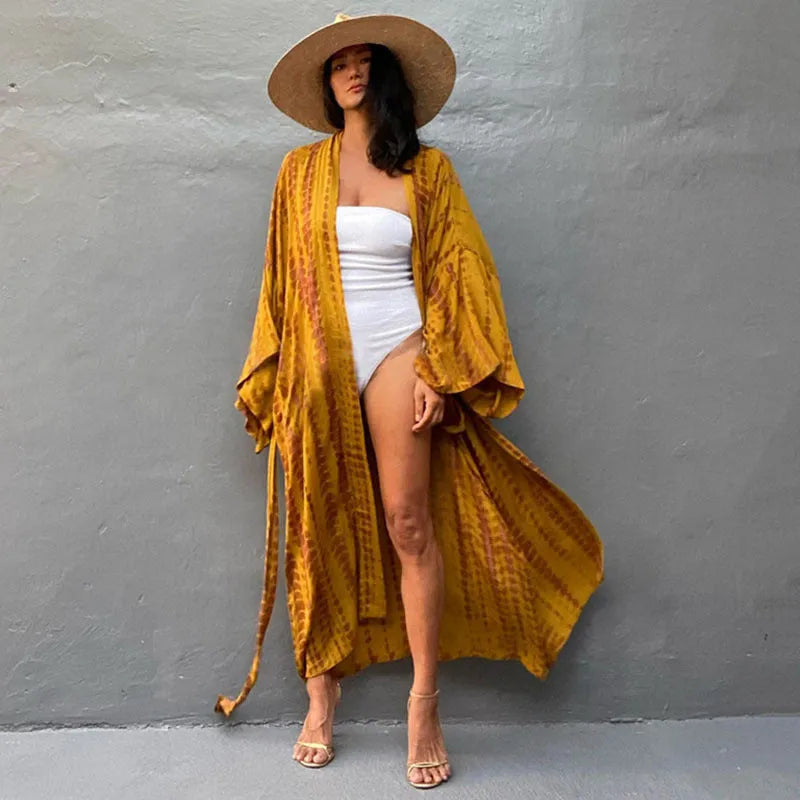 A printed, loose-fitting cotton beach cover-up blouse on a hanger, shown in a rust red colour from the DN0712 series.