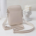 Solid colour mobile phone crossbody shoulder bag for women in PU material showing black, beige, khaki, and green colour options