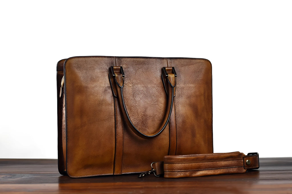 Men's brown leather horizontal business handbag with zipper closure shown from the front.