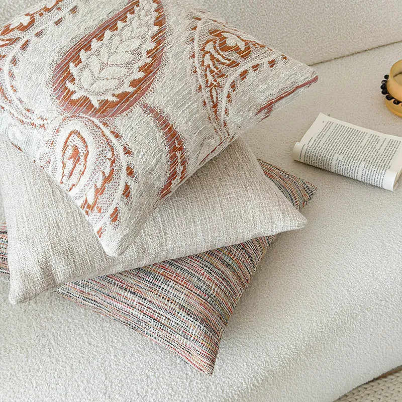American-style yarn-dyed jacquard pillow cover with paisley pattern in amber colours on sofa